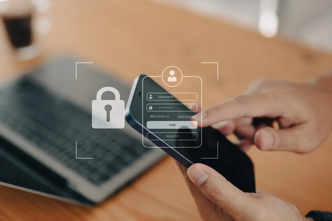 businessman-secures-his-account-mobile-phone-concept-protecting-against-hacking-phishing-online-security-threats-safeguarding-smartphones-staying-vigilant-against-online-fraud-scaled